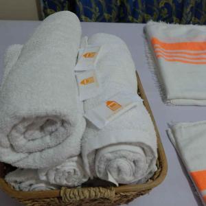 a basket filled with towels on top of a table at The Orange House - Vigan Villa in Vigan