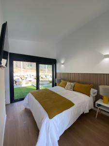 a bedroom with a large bed and a large window at Top Balea in Pontevedra