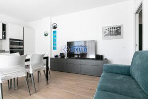 een woonkamer met een bank en een tafel en stoelen bij Residence Baia Bianca in Lido di Jesolo