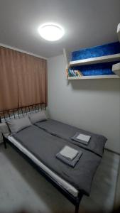 a bedroom with a large bed in a room at Apartman Gold in Tuzla