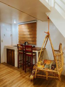 a room with a kitchen with a hammock and a table at The River House - Loft Units in Vigan
