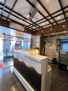 a kitchen with a counter in a restaurant at Sharan Residency in Navi Mumbai