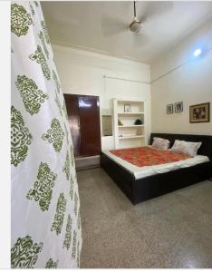 a bedroom with a bed in a room at Suite with an airy rooms in Kānpur