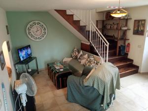 a living room with a couch and a staircase at Apartment with pool Aircon & mountain views in Gallinaro