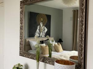 a mirror on a wall in a room with a bed at Follies Suites Ballyvoile in Dungarvan