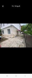 two photographs of a building and a stone street at Avtokarkhana. Chkalovi N14 in Kutaisi