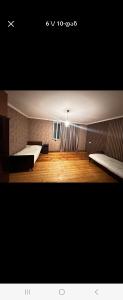 a large room with two beds and a light at Avtokarkhana. Chkalovi N14 in Kutaisi