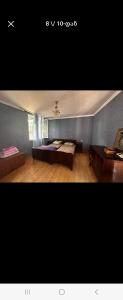 a room with a bed and a table in it at Avtokarkhana. Chkalovi N14 in Kutaisi