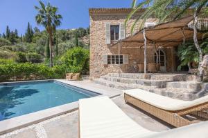 a villa with a swimming pool and a house at ES CLOT in Deia