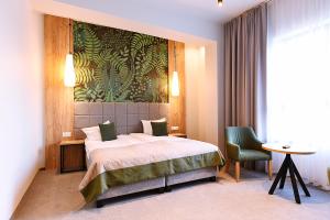 Ein Bett oder Betten in einem Zimmer der Unterkunft FOLGA - Hotel, Restauracja, Browar, SPA