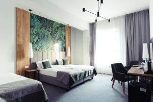 Ein Bett oder Betten in einem Zimmer der Unterkunft FOLGA - Hotel, Restauracja, Browar, SPA