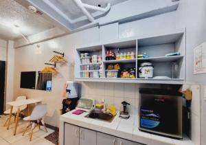 a kitchen with a sink and a counter top at Small Apartment Near SM North Project 7 in Manila