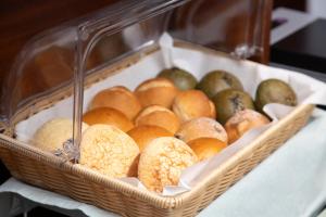 a basket filled with breads and pears on a table at KOKO HOTEL Sendai Kotodai Park in Sendai