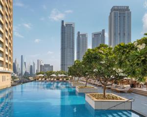 a large swimming pool with a city skyline in the background at Kempinski Central Avenue Dubai in Dubai