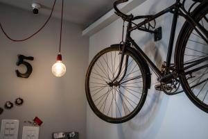 a bike hanging from a wall in a room at Acolá Sport Hostel in Pontevedra