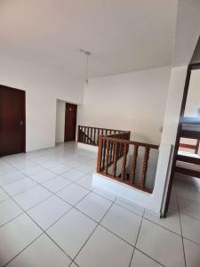 a room with a white tile floor and a staircase at POUSADA MARINHA DO CEU in Maceió