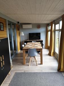 a dining room with a wooden table and chairs at Apartamenty pod Wilczakiem in Złotoryja