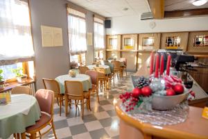 a dining room with tables and chairs in a restaurant at Pansion Maltar Varaždin in Varaždin +37 photos