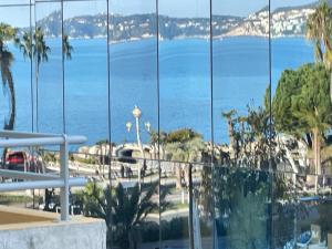 a view of the ocean from a hotel window at STUDIO SUR LA PROMENADE DES ANGLAIS AVEC VUE MER ORIGINALE À 40 m DE LA PLAGE in Nice