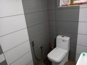 a bathroom with a white toilet in a room at MALANAD GUEST HOUSE THENGIPALAM CHENAKAL UNIVERCITY ROAD 