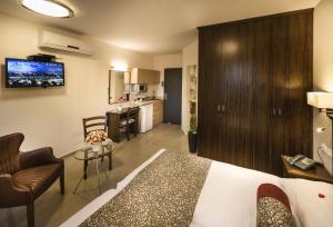 a hotel room with a bed and a kitchen at City Center Jerusalem in Jerusalem