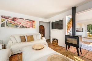 a living room with a couch and a wood stove at Cala Salada Sunset View in San Antonio