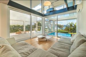 a living room with a couch and large windows at Miramar 9 Manresa in Alcudia
