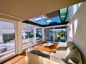 ein Wohnzimmer mit einem Sofa und einem Tisch in der Unterkunft Seafront Villa Sunset Alcudia in Alcúdia