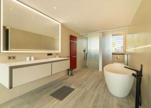 a bathroom with a large tub and a large mirror at Miramar 9 Manresa in Alcudia +16 photos