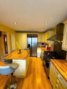 a kitchen with wooden floors and a stove top oven at Dundridge Home - Morden Urban Living - Sleeps up to 9 guests & private parking for 2 vehicles in Bristol