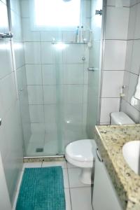 a bathroom with a shower and a toilet and a sink at Natal Verano Ponta Negra in Natal