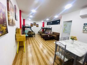 a living room with a couch and a table and chairs at Zenhouse Calayo in Nasugbu