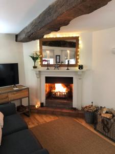 a living room with a fireplace with a mirror at Shining Star, Cartway River Views in Bridgnorth