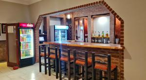 a bar in a restaurant with a brick wall at Summerset Place Country House in Bela-Bela