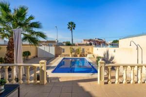 a swimming pool in the backyard of a house at Charming House with private pool in urb saint Louis in Torrevieja