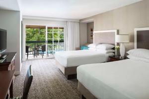 a hotel room with two beds and a balcony at Hyatt Regency Newport Beach in Newport Beach