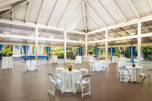 a banquet hall with white tables and chairs at Hyatt Regency Newport Beach in Newport Beach