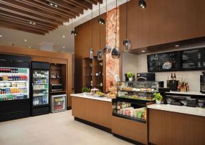 a restaurant with a food counter and a refrigerator at DoubleTree by Hilton Irvine Spectrum in Irvine