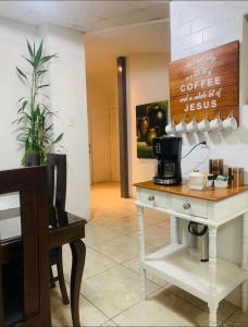 a coffee shop with a table with a coffee maker at Hostal Rio Piedra in Estelí +22 photos