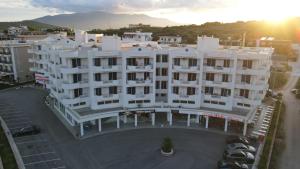 an aerial view of a white building with a parking lot at CAPTAIN'S RESIDENCE in Ksamil