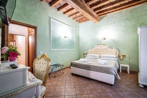 a bedroom with a bed in a room with green walls at Katti House in Florence