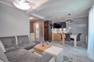 a living room and kitchen with a couch and a table at Apartment in Międzyzdroje with Furnished, Green Balcony SeaView by Rent like home in Międzyzdroje