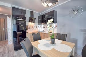 a dining room with a wooden table and chairs at Apartment in Międzyzdroje with Furnished, Green Balcony SeaView by Rent like home in Międzyzdroje