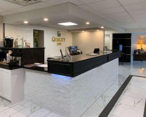 an empty lobby with a counter in a restaurant at Quality Inn & Conference Centre Downtown Sudbury in Sudbury