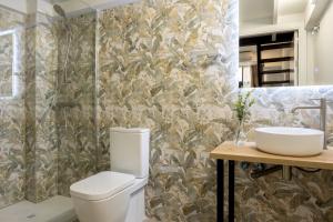 a bathroom with a toilet and a sink at Lore Loft Valencia in Valencia
