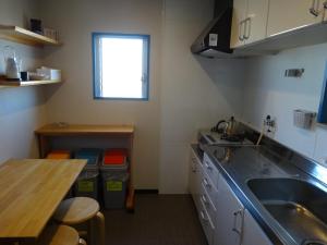 a small kitchen with a sink and a table at SYO Heights 501-3Bed in Osaka