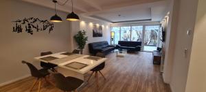 a living room with a table and a couch at Noahs Apartments in Füssen