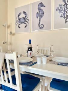 un tavolo da pranzo con piatti e dipinti a cavalluccio marino di Fuengirola Sol - Apartamento Céntrico y Luminoso a Fuengirola