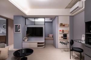 a living room with a tv and a couch at Lin Apartments by Olala Homes in Taipei