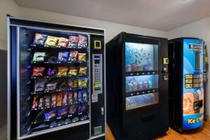 two vending machines with food and drinks in a room at WoodSpring Suites Columbus Southeast in Groveport